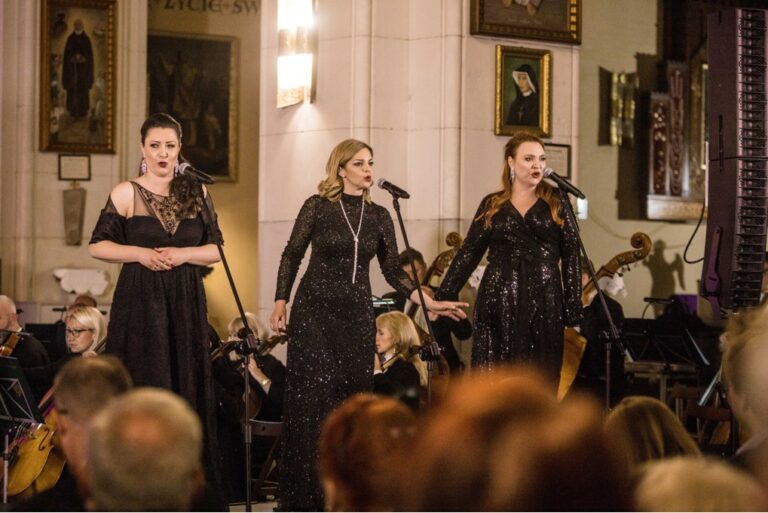 a group of women singing on stage